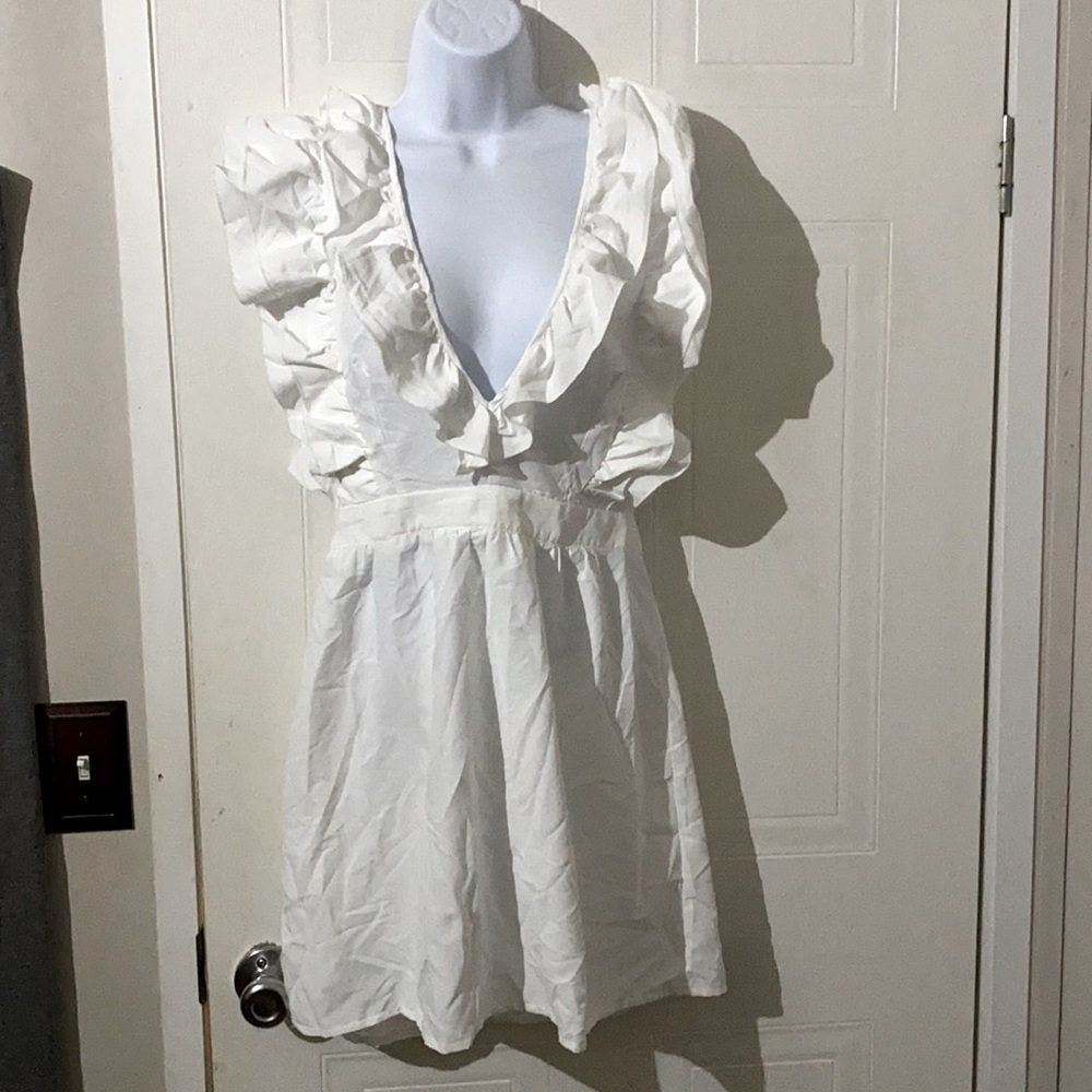 Brand new with tag, never worn, sleeveless, tie around the neck mini dress